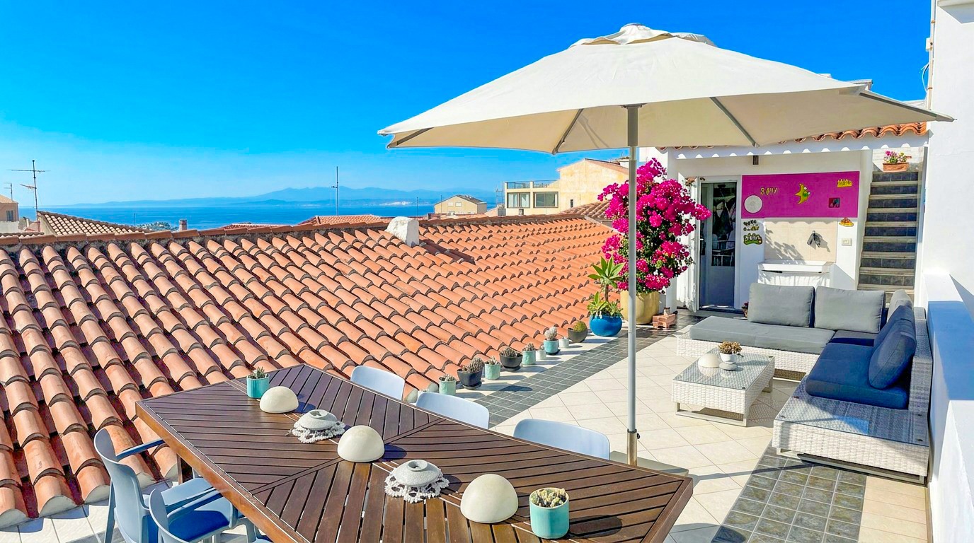 Terrazza con ombrellone e vista sui tetti — B&B Domus de Janas